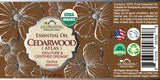 US Organic Cedarwood Atlas essential oil 30 mL wraparound label with safety information and barcode.